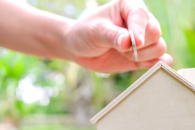 A close-up of a hand installing insulation made from recycled materials in a home's attic, emphasizing energy efficiency and use of sustainable resources.
