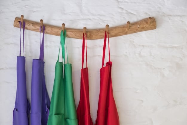 Close-up of a variety of colorful reusable shopping bags hanging on hooks in a well-lit kitchen, showcasing different materials and patterns.