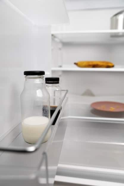 Close-up of a refrigerator interior showing strategically placed containers of water and food to maintain optimal temperature and airflow.