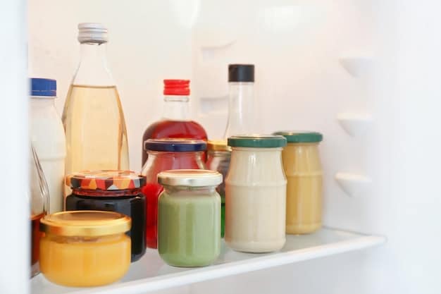 Close-up shot of a well-organized refrigerator filled with reusable containers, glass jars, and produce stored in breathable bags, showcasing a commitment to reducing food waste and plastic consumption in the kitchen.