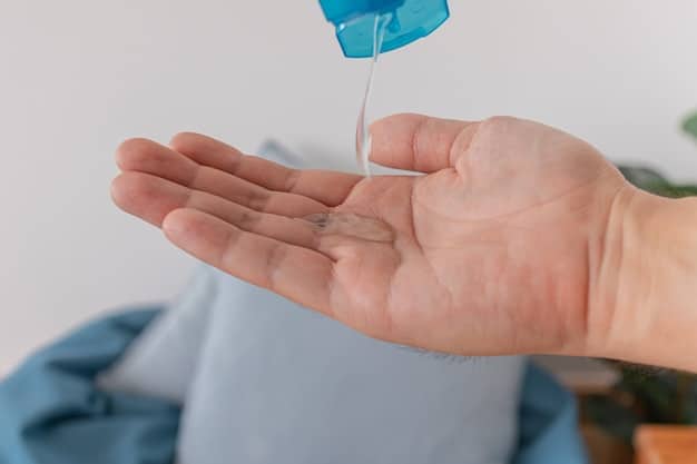 A close-up of a hand pouring a clear, plant-based laundry detergent from a recycled paper carton into a washing machine dispenser. The detergent is labeled 
