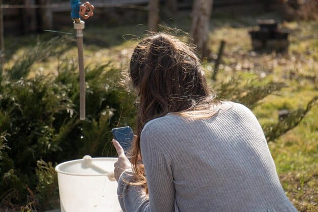 A person filling a reusable water bottle from a water fountain in a park, with lush greenery and a diverse group of people in the background.