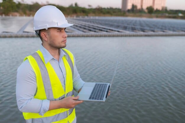 An engineer inspecting a floating solar panel on a body of water. The engineer is wearing safety gear and is holding a tablet, indicating data monitoring and analysis. The background shows a vast expanse of solar panels and the surrounding landscape.