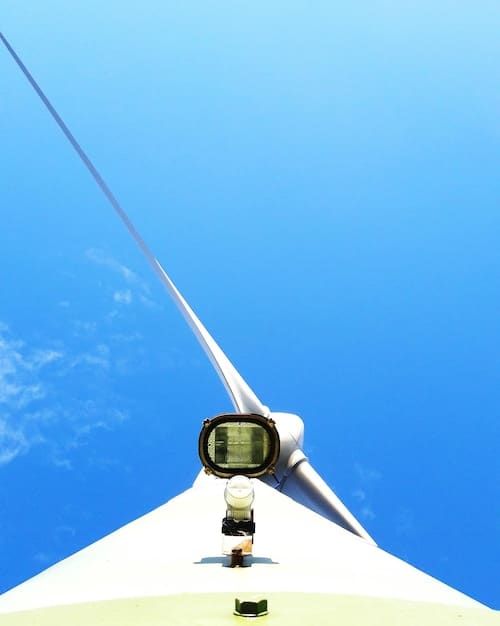 A close-up image of an ultrasonic anemometer installed on a wind turbine, showing its compact design and rugged construction.
