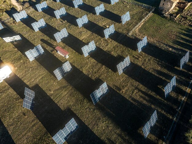 A series of smaller, more efficient heliostats arranged in a field, each reflecting sunlight onto a central receiver tower. The image focuses on the reduced size and improved tracking precision of these modern heliostats.