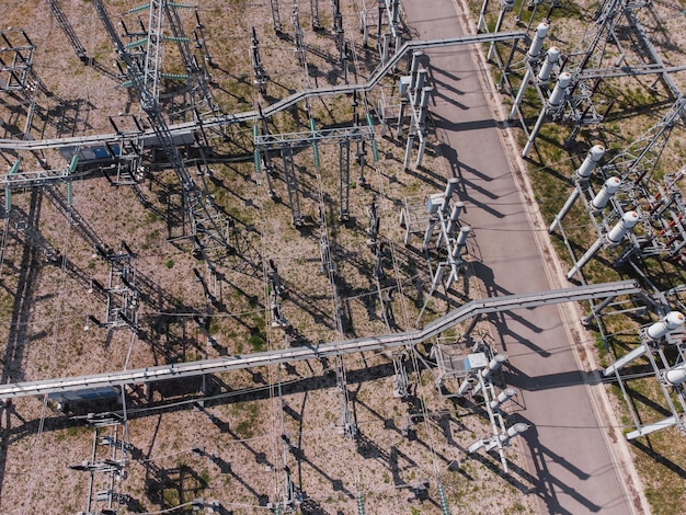 An aerial shot of a sprawling, interconnected smart grid system, highlighting transmission lines, substations, and distribution networks across a diverse landscape of urban and rural areas. The image emphasizes the complexity and infrastructural advancements needed for renewable energy integration.
