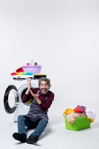 A person carefully loading a washing machine with a mixed load of clothing, showing attention to not overloading it.