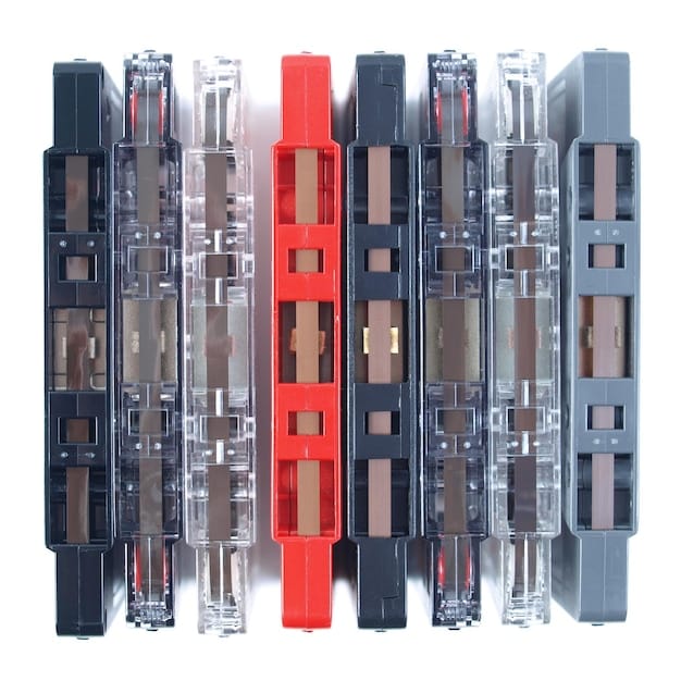 A close-up of a grid-tied inverter with various ports and labels clearly visible. The inverter is mounted on a wall in a residential setting. Wires are connected to the inverter, showcasing its integration with the home's electrical system.