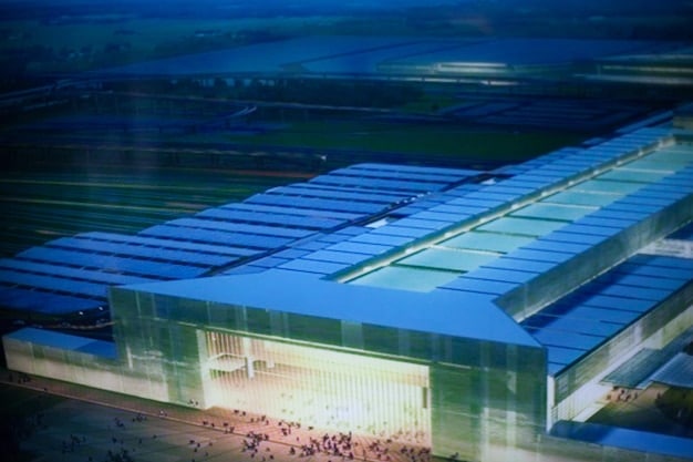 A modern energy storage facility with rows of large batteries connected to a renewable energy grid, illustrating the importance of energy storage in managing intermittent renewable energy sources.