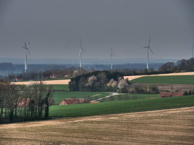 A wind farm located in a rural area, with rolling hills and agricultural fields surrounding the turbines.