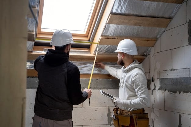 Workers installing insulation in the attic of a house, with a focus on safety and proper installation techniques.