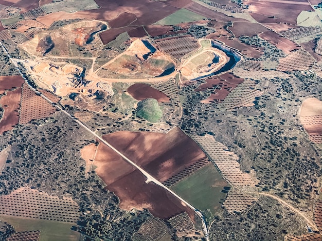 A satellite image showing a large-scale solar power plant in the desert, surrounded by untouched natural habitat. The image highlights the land use implications of large-scale solar projects.