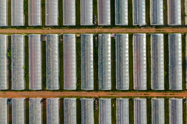 An aerial view of a large-scale battery storage facility connected to a solar panel farm, illustrating the synergy between renewable energy generation and storage solutions.